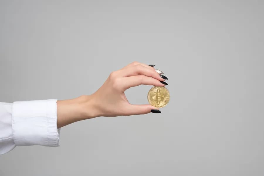 Hand holding a crypto coin