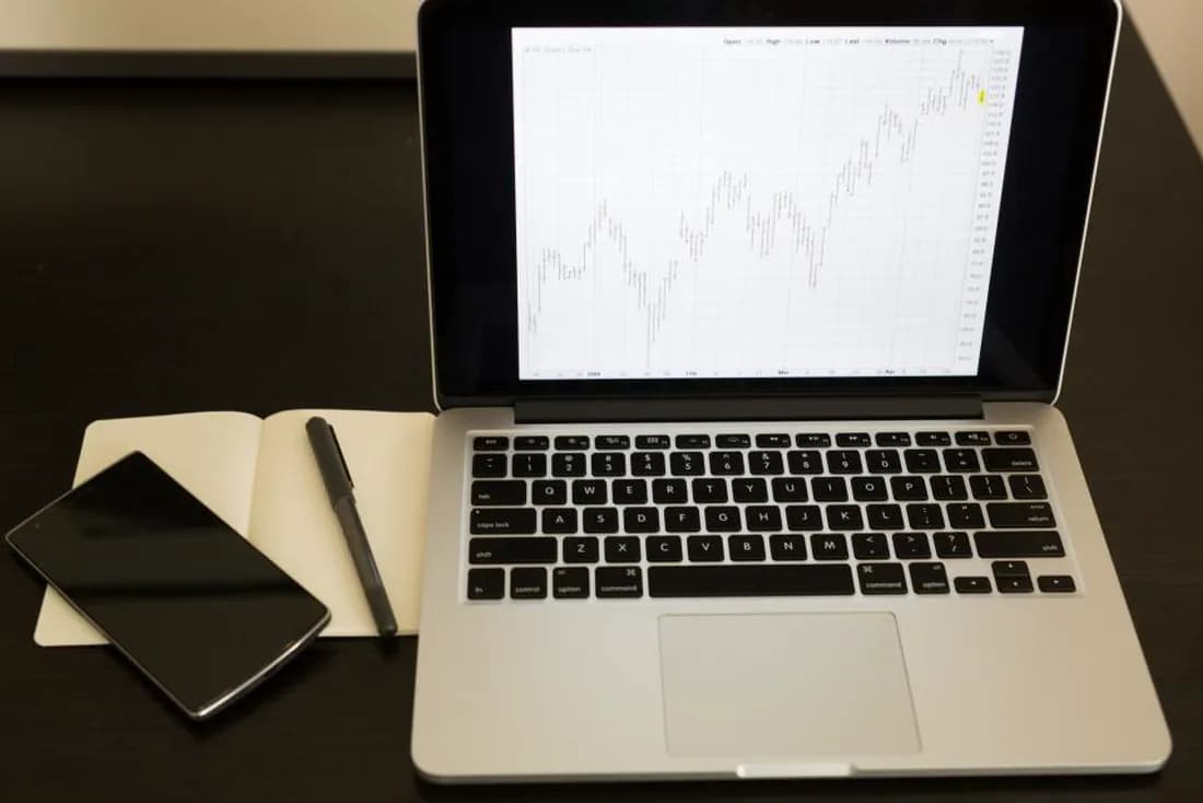 Laptop showing a candlestick chart